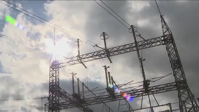 Sun shines through clouds over a power substation in Austin, Texas, in 2022.