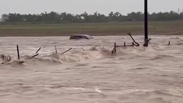 A vehicle is swept away in floodwater in Uvalde County, Texas, on July 14, 2026.